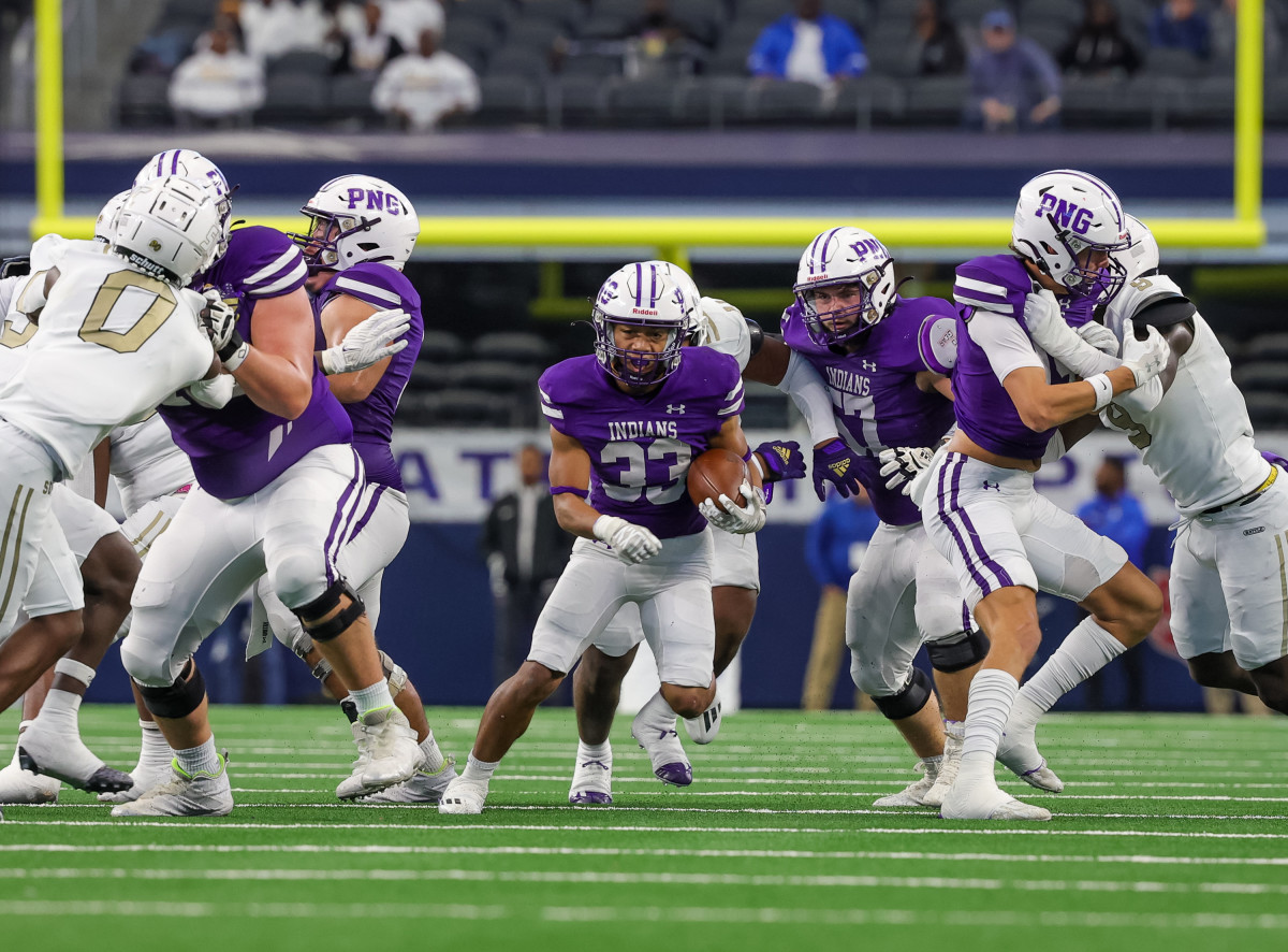 Isaiah Nguyen takes a carry during the first half of the 5A Division II Texas UIL state title on Saturday at AT&T Stadium. The PNG running back 