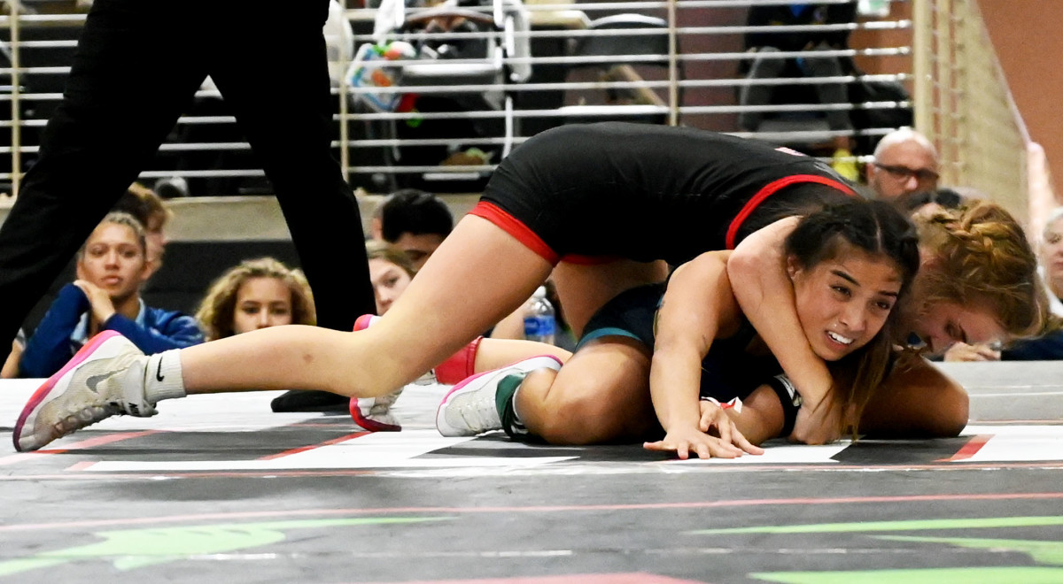 Camdyn Elliott from Well Trained gets a victory against Annalise Marshall from Ashley Ridge in the 100-pound championship match at the Knockout Christmas Classic at Silver Spurs Arena in Kissimmee on Thursday.