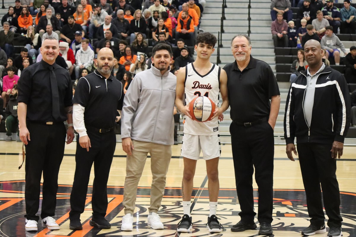 Davis' Cesar Hernandez, holding ball, is honored before a nonleague game against Richland in Yakima on Friday, Dec. 29, 2023.