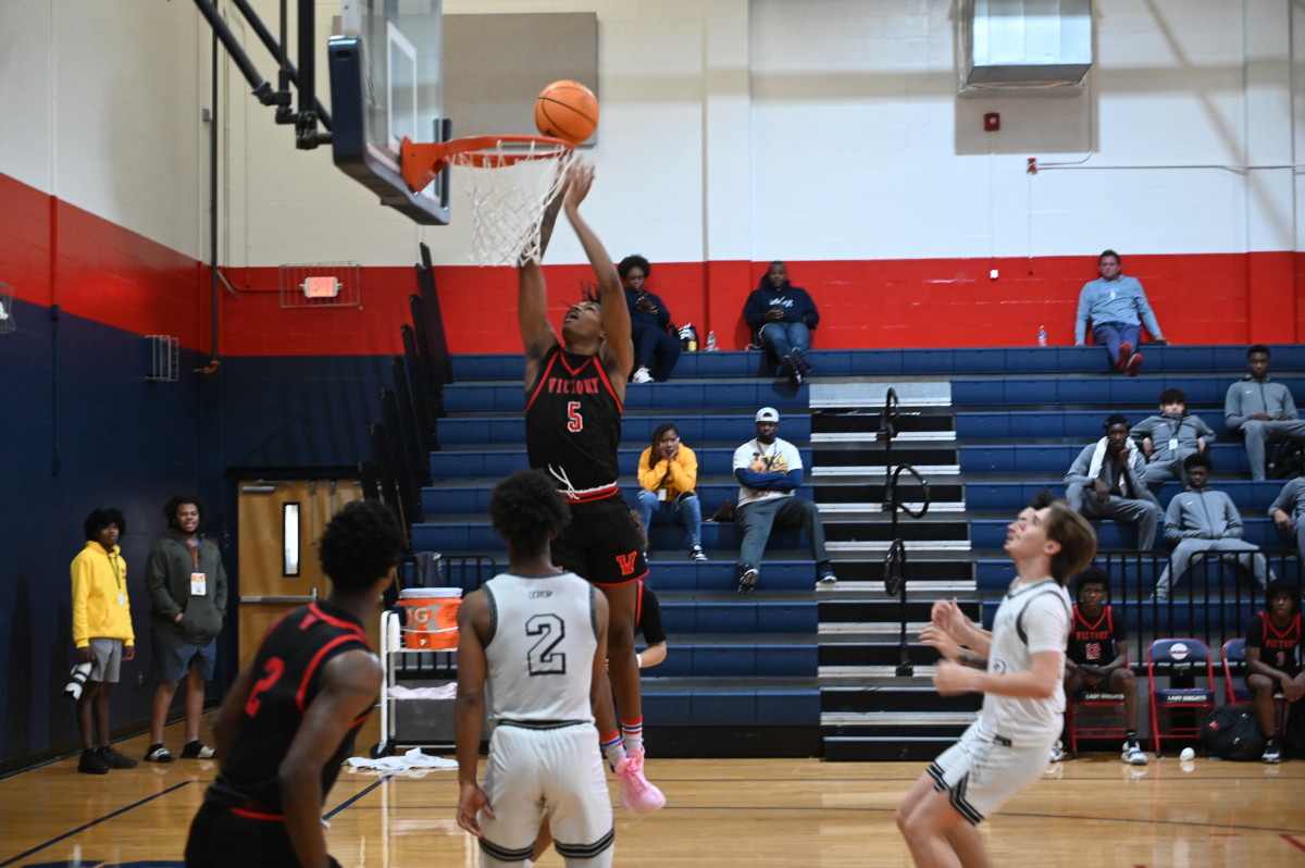 Senior Lorenzo Cason from Victory Christian goes up for the finger-roll jam during the Consolation Final against Mariner. He scored 27 points and was named to the All-Tournament team.
