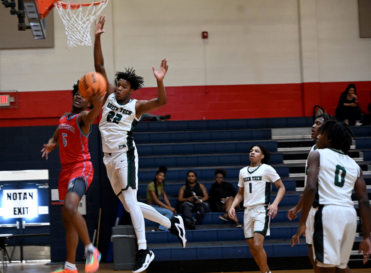 Kiori Jordan-Thomas from Rockledge drives under the basket while Olivan Owens from Albany Green Tech defends during the fifth-place game at the Kingdom in the Sun Tournament at Vanguard High School in Ocala. 