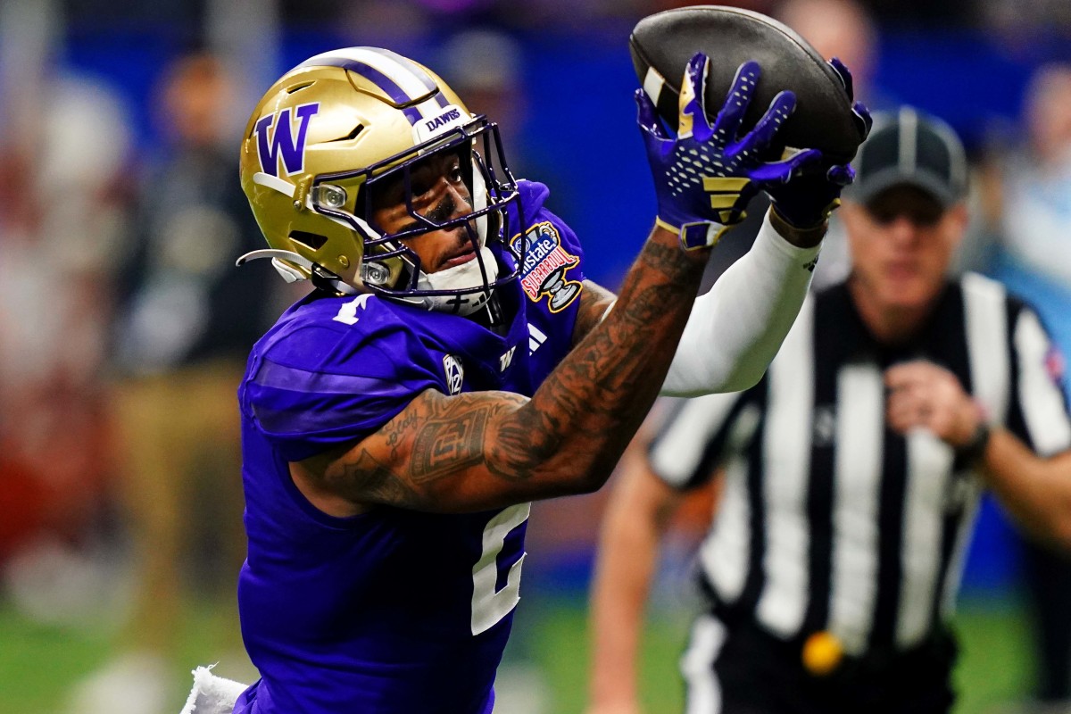Jan 1, 2024; New Orleans, LA, USA; Washington Huskies wide receiver Ja'Lynn Polk (2) catches a touchdown pass during the second quarter against the Texas Longhorns in the 2024 Sugar Bowl college football playoff semifinal game at Caesars Superdome. Mandatory Credit: John David Mercer-USA TODAY Sports