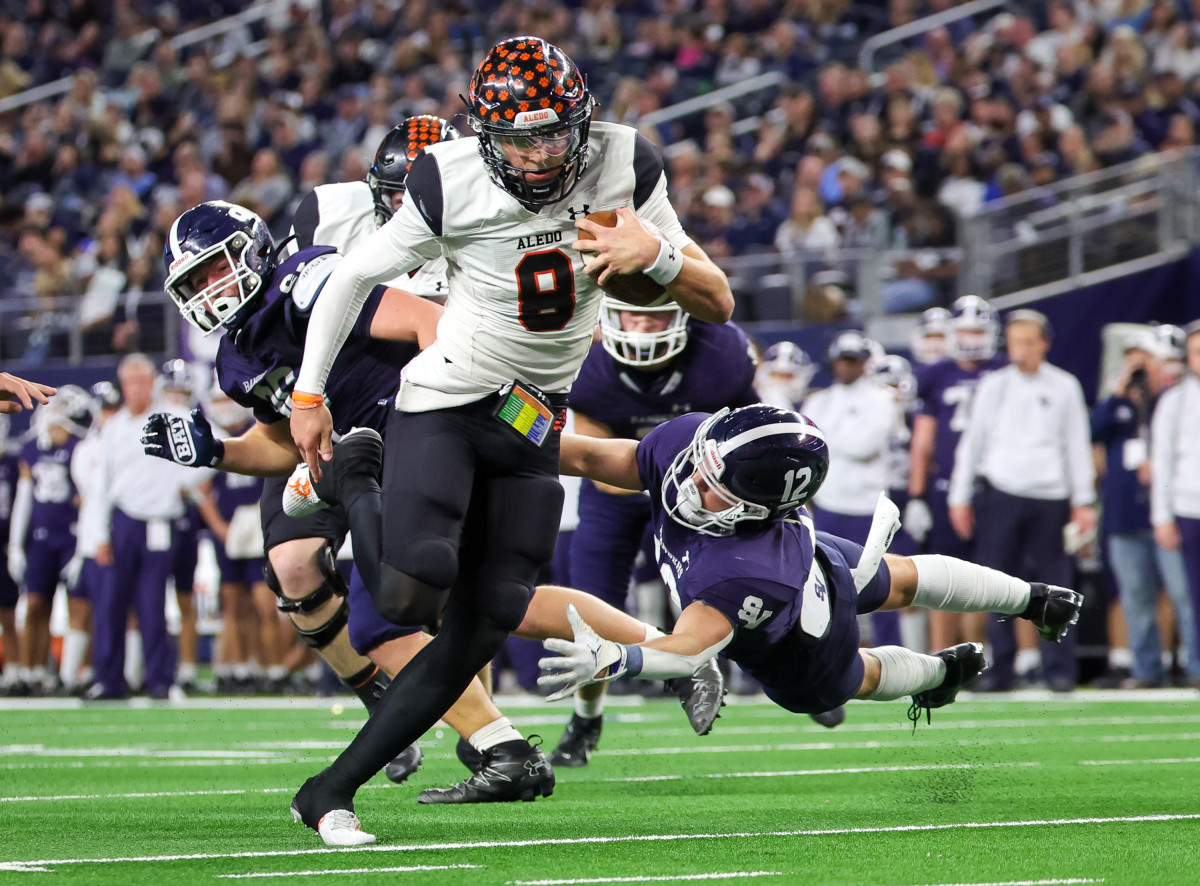 Aledo do-it-all QB Hauss Hejny charges through contact into the open field in the Class 5A Division I state championship in December at AT&T Stadium.