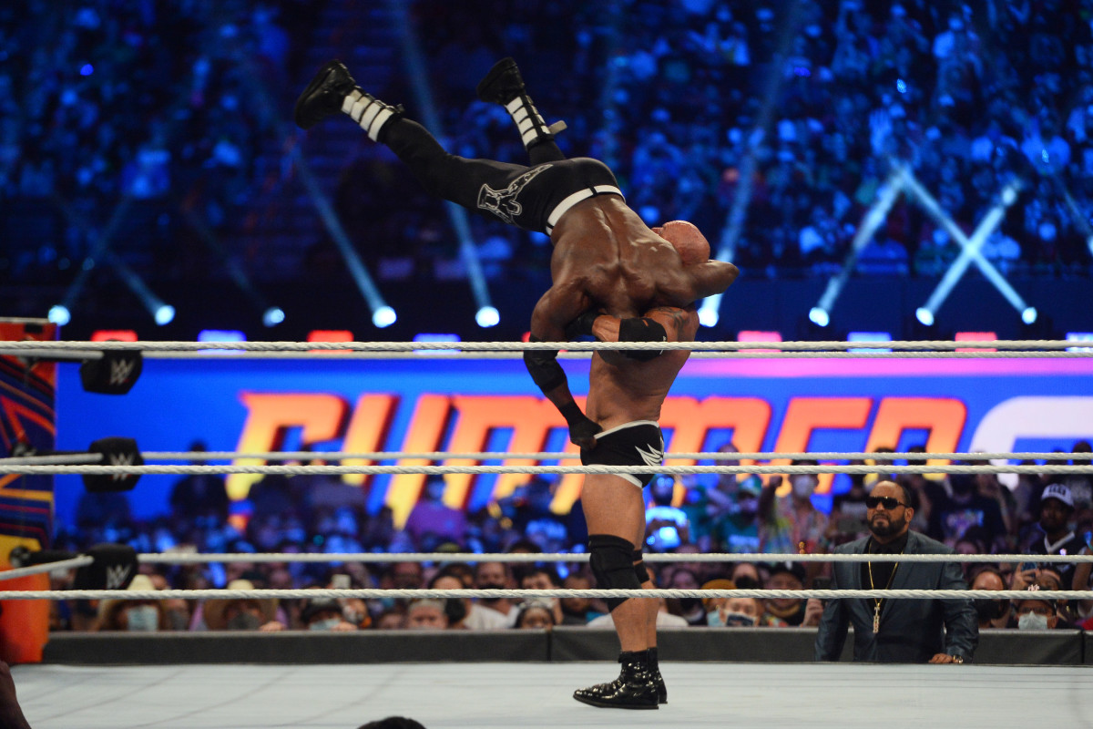 WWE wrestler Goldberg (black trunks) throws Bobby Lashley (black pants) at the WWE World Heavy Championship at SummerSlam 2021 at Allegiant Stadium. 