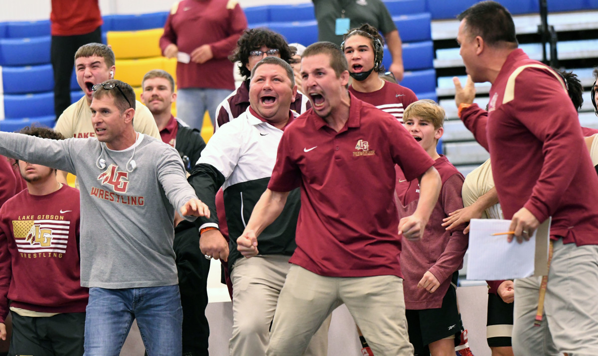 Lake Gibson head coach Danny Walker (center white and black shirt) reacts with his coaching staff during a crucial moment in the 2A championship duel against Fleming Island at the FHSAA Duals Wrestling State Championships this past year at Osceola High School in Kissimmee.