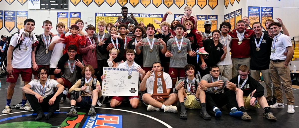 Lake Gibson wrestlers and coaches gather with the FHSAA Class 2A Duals State Championship trophy on Saturday at the FHSAA Duals wrestling state championships at Osceola High School.