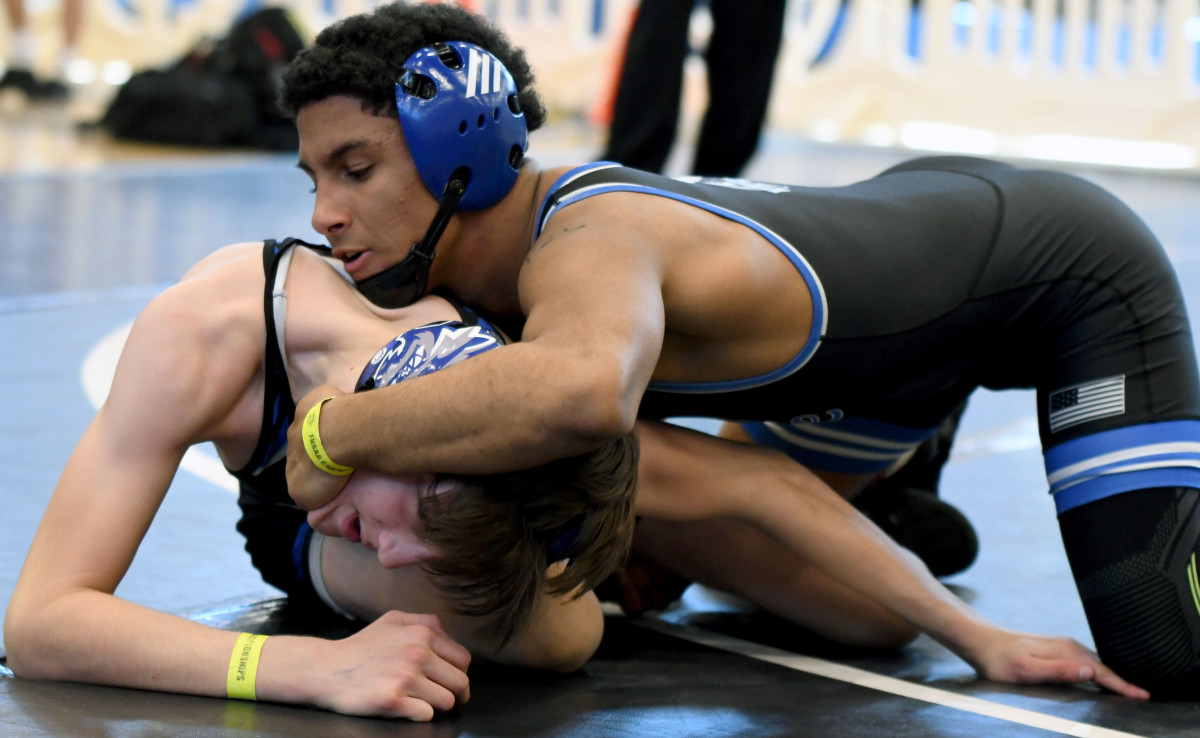 South Dade’s Luis Acevedo works his way to a tech fall win in a 120-pound match against Mark Bofantae of Wellington Community on Saturday at the FHSAA Duals wrestling state championships at Osceola High School.