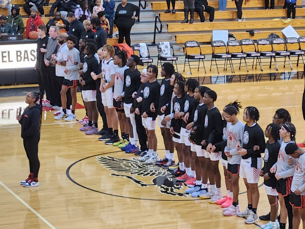 Buchtel and East basketball players stand in unison for the national anthem prior to a game on January 23, 2024