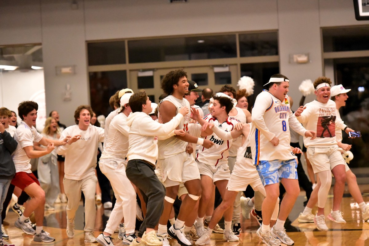 Crossings Christian players and fans celebrate after the Knights' win against Oklahoma Christian School on Jan. 26, 2024.